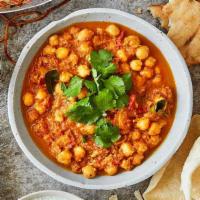 Chana Masala · Garbanzo beans cooked in onion and tomato sauce flavored with spices