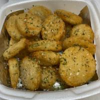 Fried Pickles · Dill sliced pickles breaded and fried. Garnished with Italian herbs and served with your cho...
