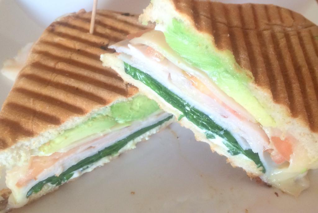 Chicken Pesto Avocado Panini · Grilled chicken breast, spinach, tomato, red onion, avocado, Swiss cheese and creamy pesto. Served on a pressed ciabatta with homemade potato salad or a side green salad and balsamic vinaigrette.