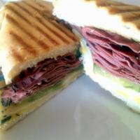 Pastrami Panini · Grilled pastrami, mustard and pickles topped with Swiss cheese. Served on a pressed ciabatta...