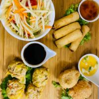 Thais New York Sampler · Root vegetable spring rolls, chicken curry puff, chicken dumpling and green papaya salad.