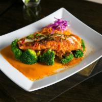 Chu Chee Salmon · Pan seared salmon with chuchee curry sauce and kaffir lime leaves. Spicy.