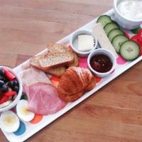 Happy Camper Breakfast · An European Breakfast Platter:
Croissant, ham, turkey, hard-broiled egg, cucumber, wheat bre...