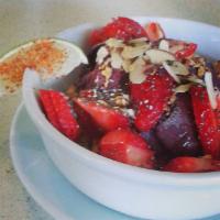 Acai Lime · Topped with fresh squeezed lime, strawberries, Tajin spices, granola and honey.