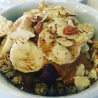 Nutty Acai · Topped with organic peanut butter, sliced almonds, banana, flax seeds, granola and honey.