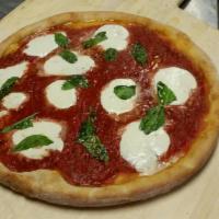 Margherita Pizza · House made tomato sauce topped with sliced mozzarella, fresh basil and oregano.