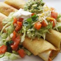Flautas  · 3 deep fried corn tortillas filled with chicken or beef topped with lettuce, guacamole, dice...