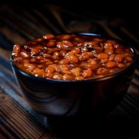 BBQ Baked Beans · Creamy Baked Beans with Pork Belly and Seasoning Topped with OG BBQ Sauce.