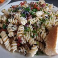 Pasta Salad · Rotelli pasto, sun-dried tomato, oil cured olives, green peppers, and red onion, tossed in L...