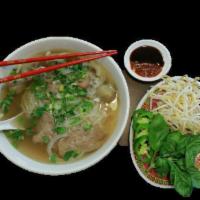 N3. Pho Noodle Soup · A rice noodle in a slow cooked homey beef broth; topped w/ onion, scallions, cilantro & choi...