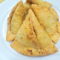 Vegi Samosa · Deep fried pastry shell stuffed with mashed boiled potato, green peas, lentils, spices and g...