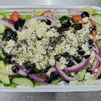 Greek Salad · Freshly made salad with lettuce, tomatoes, cucumbers, lemons, red onions, topped with black ...