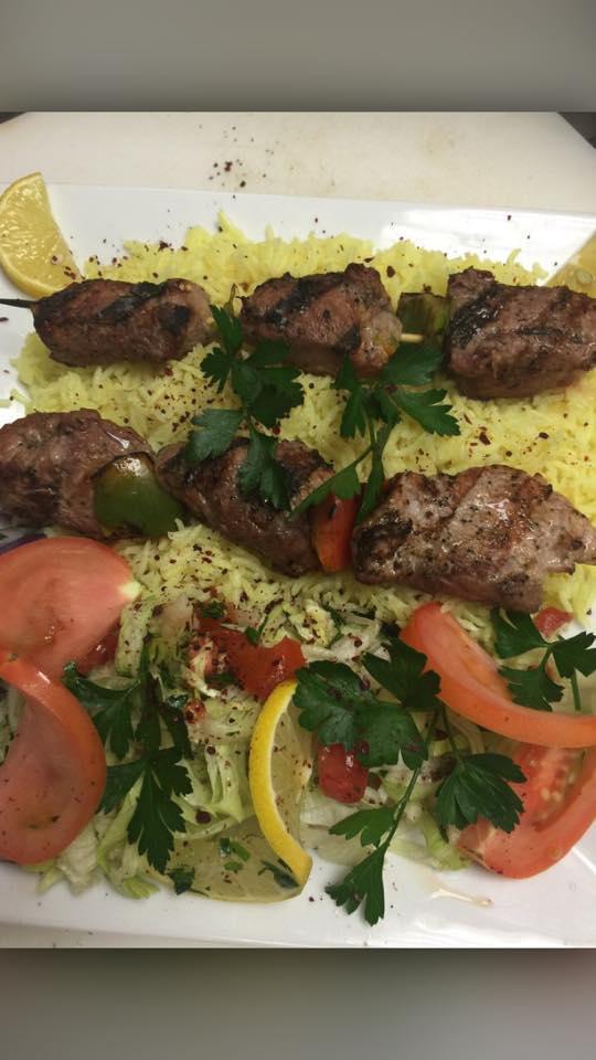 Lamb Kabob Platter · Seasoned tender grilled lamb with grilled vegetables on a bed of rice.