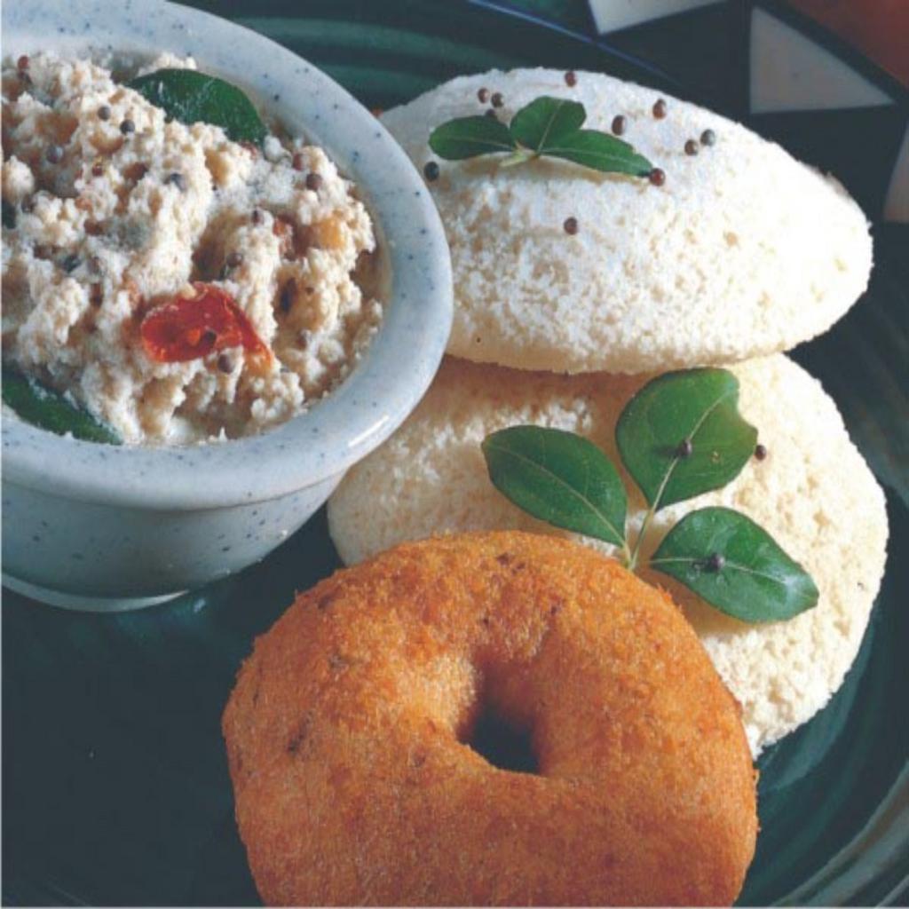 1 Idly and 1 Vada · Combination of 1 steamed rice cake and lentil doughnut served with chutney and sambar.