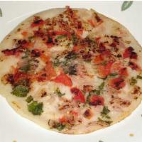 Tomato Onion Chili Uthappam · Thick rice and lentil pancake topped with tomatoes and onions and chili.