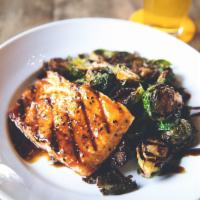 Grilled Firecracker Salmon · Freshly grilled salmon with firecracker sauce and crispy Brussels sprouts with balsamic glaze.