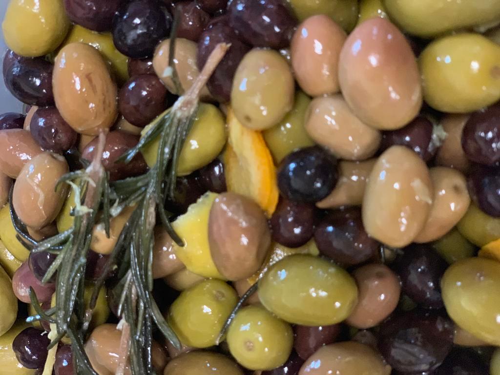 House Marinated Olives · Mixed Spanish olives bathed in olive oil with lemon and orange and fresh rosemary. Vegetarian, vegan, gluten-free.