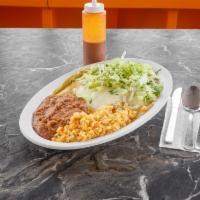 Enchilada · 4 corn tortillas bathed in green or red salsa filled with meat of your choice, and stopped w...