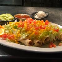 4 Taquitos con Guacamole y Garnish · 4 choice of shredded chicken or beef. Served on a bed of lettuce, sour cream, and guacamole,...