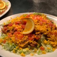 Super Tostada Favorite · A flat crisp corn tortilla topped with choice of black beans or refried, lettuce, tomatoes, ...