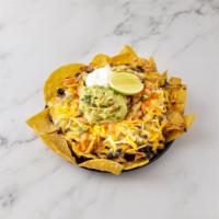 Aztec Nachos · Crispy chips, beans and jalapenos topped with melted Jack and cheddar cheese, guacamole and ...