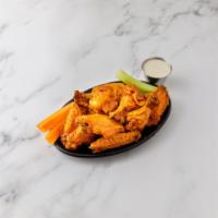 Spicy Habanero Wings · With blue cheese dip, carrot and celery sticks.