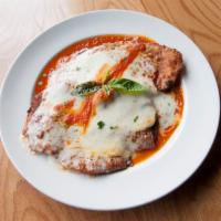 Chicken Parmigiana · Breaded cutlet, tomato sauce, mozzarella, and Parmigiano.