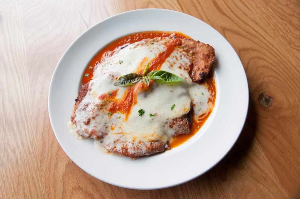 Chicken Parmigiana · Breaded cutlet, tomato sauce, mozzarella, and Parmigiano.