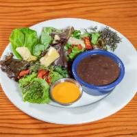 House Salad · Mixed greens, artichokes, red peppers and sun-dried tomatoes with a side of black beans.