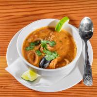Asopado de Mariscos · Seafood soup mixed with rice.