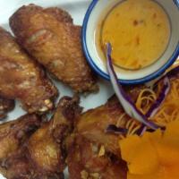 A7. 6 Piece Chicken Wings · Marinated chicken wings in zesty Thai herbs and fried until golden brown. Served with sweet ...