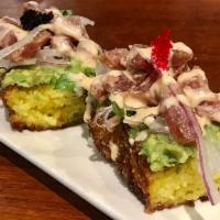 Turmeric Crispy Tuna Poke · Turmeric crispy crust rice, avocado, tobiko, onions, arugula, tuna poke, oyster reaper aioli