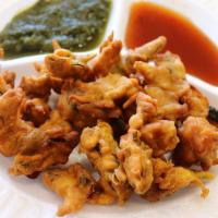 Vegetable Pakora · Mixed vegetable fritters batter fried with chickpea flour.