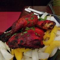 Chicken Tandoori · Bone-in chicken marinated in yogurt, herbs and spices. Baked to perfection in a clay oven. P...