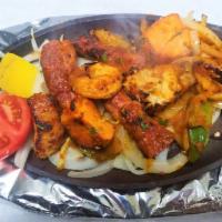 Mixed Grill · A variety of chicken tikka, reshmi kabab, seekh kabab and tandoori shrimp. Prepared in a cla...
