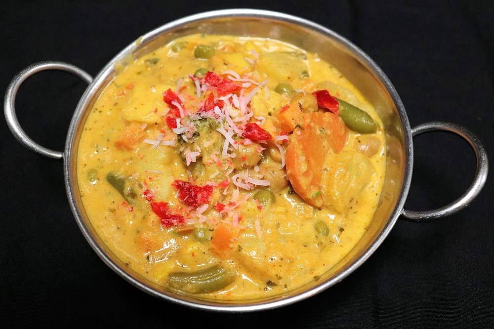 Chicken Korma · Chicken cooked in mild curry sauce with vegetables, nuts, raisins, and coconut.