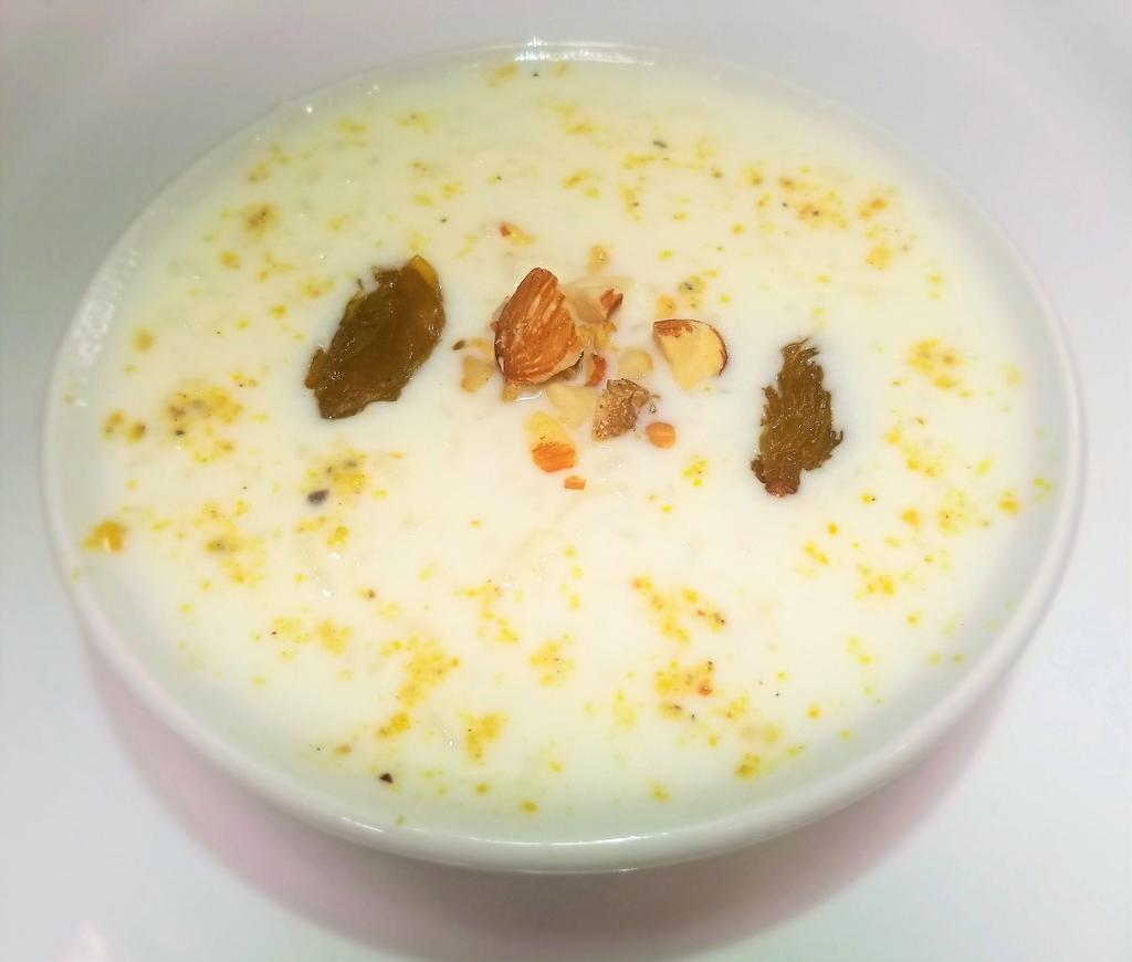 Kheer · 8oz. Delicious rice pudding, garnished with almonds, nuts and raisins.