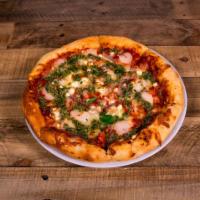 Creole Italian Pizza · Red sauce, spiced shrimp, Roma tomatoes, feta, red onions, mozzarella and pesto sauce.