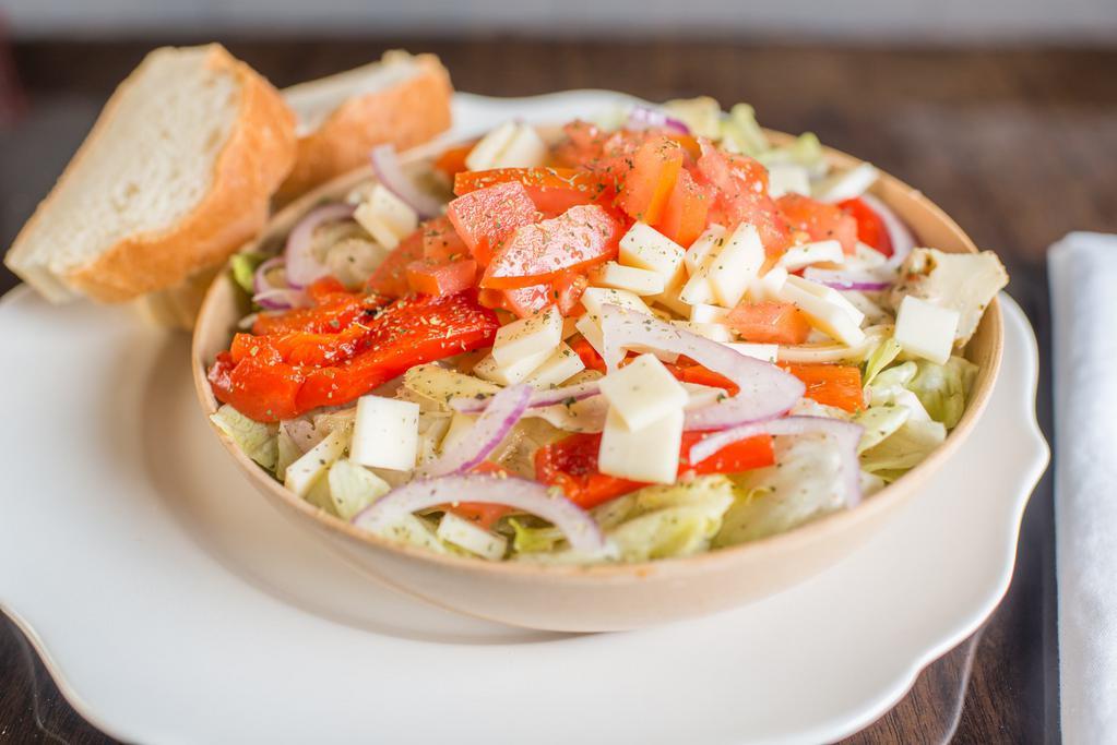 Garden Salad · Artichoke hearts, domestic provolone cheese, roasted red peppers, on top of a bed of fresh-cut lettuce, then topped with Roma tomatoes, red onions, and choice of dressing.