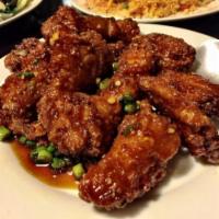 87. Korean Chicken Wings · Deep fried chicken wings sauteed with garlic, green onion in our special homemade sweet and ...