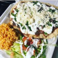 Guarache · Soft opened faced large fresh tortilla topped with beans, meat, crumbled queso fresco, crema...
