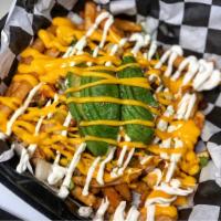 Al Pastor Fries · Crispy Fries topped with Al pastor meat, Pico de gallo, melted nacho cheese, crema and slice...