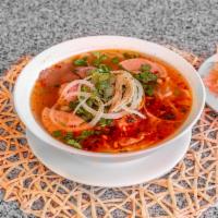 Bun Bo Hue Dinner · Hue spicy noodles. Large round rice noodle in a spicy broth with beef and pork slices, shrim...
