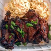 Kal-Bi Ribs · Grilled Thin Cut Beef Short Ribs in Korean Marinade. Served with Rice and Choice of Mac Sala...