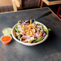 BTC Ensalada · Mixed greens topped with fresh tortilla strips, cotija cheese, pickled red onions and tomato...
