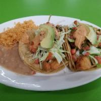 Fish Taco Plate · 2 fish tacos, topped with cabbage, pico de gallo and salsa. Served with rice and beans or fr...