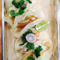 Grilled Fish Tacos · 2 tacos in grilled tortillas and served with fennel salad and tartar sauce.