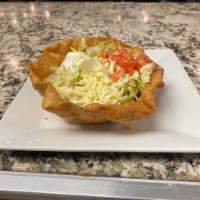 Taco Salad · A crispy flour tortilla bowl with beans, melted cheese, and your choice of shredded chicken ...