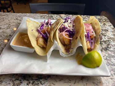 3 Tacos del Mar · Flour or corn tortillas with choice of shrimp or tilapia fillet. Topped with shredded cabbage, red onion and chipotle sauce. 