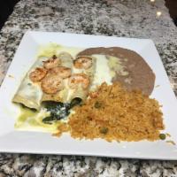 Enchiladas Blancas · 3 cheese and spinach enchiladas topped with white queso sauce and grilled shrimp. Served wit...